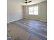 Bedroom featuring new gray floors, a modern ceiling fan, and a bright window at 307 7Th St, Butner, NC 27509
