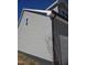 Side view of home with horizontal siding and dark gutters at 307 7Th St, Butner, NC 27509