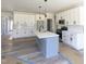 Kitchen with quartz countertops, stainless steel appliances, and a gray kitchen island at 307 7Th St, Butner, NC 27509