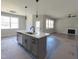 Kitchen with a center island, stainless steel sink, modern fixtures, and an open floor plan at 307 7Th St, Butner, NC 27509