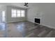 Living room featuring a fireplace, hardwood floors, a ceiling fan, and lots of natural light at 307 7Th St, Butner, NC 27509