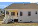 The backyard features a covered porch, stairs, and white siding at 336 Pecan Valley Way, Four Oaks, NC 27524