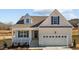 Charming home featuring white siding, blue shutters, and an attached two-car garage at 336 Pecan Valley Way, Four Oaks, NC 27524