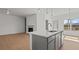 Bright open concept kitchen with stainless steel appliances, island with breakfast bar at 336 Pecan Valley Way, Four Oaks, NC 27524