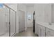 Main bathroom with glass shower and double sink vanity with storage space at 336 Pecan Valley Way, Four Oaks, NC 27524