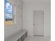 Bright mudroom with a bench, hooks and natural light at 336 Pecan Valley Way, Four Oaks, NC 27524