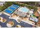 Aerial view of community amenities: tennis courts, pool, clubhouse, playground, and parking lot at 3659 Coach Lantern Ave, Wake Forest, NC 27587