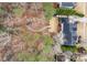 Aerial view of backyard with deck, rocky lawn, path, and surrounding trees at 3659 Coach Lantern Ave, Wake Forest, NC 27587