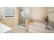 Bright bathroom featuring a shower and soaking tub at 3659 Coach Lantern Ave, Wake Forest, NC 27587