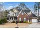 Charming two-story home featuring a welcoming front porch, well-maintained lawn, and attached garage at 3659 Coach Lantern Ave, Wake Forest, NC 27587