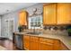 Kitchen featuring ample cabinetry, stainless steel dishwasher, and open access to back deck at 3659 Coach Lantern Ave, Wake Forest, NC 27587