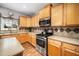 Well-lit kitchen featuring light wood cabinets, stainless steel appliances, and tile backsplash at 3659 Coach Lantern Ave, Wake Forest, NC 27587
