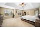 Large bedroom with tray ceiling, two large windows, and access to en suite bath at 3659 Coach Lantern Ave, Wake Forest, NC 27587