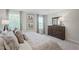 Bedroom with framed prints above the bed, large windows, and light gray wall color at 14 Artesa Ct, Fuquay Varina, NC 27526
