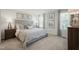 Bedroom featuring a large bed, bedside tables, and two windows with gray curtains at 14 Artesa Ct, Fuquay Varina, NC 27526