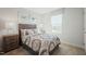 Comfortable bedroom featuring a patterned bedspread, bedside tables, and bright window at 14 Artesa Ct, Fuquay Varina, NC 27526