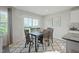 Bright dining room with a table for six and a large window at 14 Artesa Ct, Fuquay Varina, NC 27526