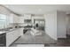 Modern kitchen features granite countertops, stainless steel appliances, and a kitchen island at 14 Artesa Ct, Fuquay Varina, NC 27526