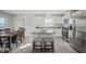 Open-concept kitchen with a kitchen island, modern appliances, and dining area at 14 Artesa Ct, Fuquay Varina, NC 27526
