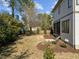 A spacious backyard with an iron fence, mulch beds, and newly planted trees at 3727 Bellevue Rd, Raleigh, NC 27609