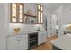Butler pantry with glass cabinets, lighting and a wine refrigerator at 3727 Bellevue Rd, Raleigh, NC 27609