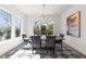 Elegant dining room with large windows providing natural light and a stylish chandelier at 3727 Bellevue Rd, Raleigh, NC 27609
