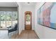 Light-filled entryway with hardwood floors, arched doorway, and view into the home office at 3727 Bellevue Rd, Raleigh, NC 27609
