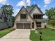 Beautiful two-story home with stone and siding exterior, a well-manicured lawn, and a spacious driveway at 3727 Bellevue Rd, Raleigh, NC 27609