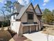 Striking two-story home with stone and siding exterior, showcasing a spacious driveway and two-car garage at 3727 Bellevue Rd, Raleigh, NC 27609