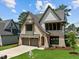 New two-story home boasts a manicured lawn, brickwork and a three-car garage at 3727 Bellevue Rd, Raleigh, NC 27609