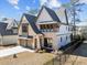 Charming two-story home featuring a stone and siding exterior, a two-car garage, and manicured landscaping at 3727 Bellevue Rd, Raleigh, NC 27609