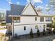 Rear exterior view of a two-story home with a fenced yard, a stone archway, and a screened porch at 3727 Bellevue Rd, Raleigh, NC 27609