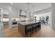 Modern kitchen featuring a large center island with bar seating, custom cabinetry, and stainless appliances at 3727 Bellevue Rd, Raleigh, NC 27609