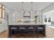 This kitchen showcases a large center island with bar seating, stylish pendant lights, and custom cabinetry at 3727 Bellevue Rd, Raleigh, NC 27609
