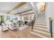 Open-concept living room featuring wood beam ceilings, fireplace, and direct access to outdoor living at 3727 Bellevue Rd, Raleigh, NC 27609