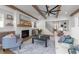 A cozy living room features a brick fireplace, exposed beams, and hardwood floors at 3727 Bellevue Rd, Raleigh, NC 27609