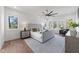 A luxurious main bedroom suite with an ensuite bathroom, large windows, and a ceiling fan at 3727 Bellevue Rd, Raleigh, NC 27609