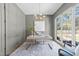 Well-lit office space with a large window, modern chandelier, and stylish decor at 3727 Bellevue Rd, Raleigh, NC 27609