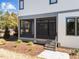 The back of the house has a screened porch with steps down to a stone walkway at 3727 Bellevue Rd, Raleigh, NC 27609