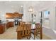 Bright dining area adjacent to kitchen features natural light, chandelier, and wood table at 38 Parkside Dr, Lillington, NC 27546