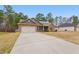 Charming single-story brick home with an attached two-car garage and a long driveway at 38 Parkside Dr, Lillington, NC 27546
