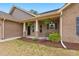 Inviting front porch with brick columns, decorative plants, and a welcoming entrance at 38 Parkside Dr, Lillington, NC 27546