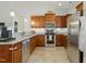 Modern kitchen features granite countertops, stainless appliances and ample wood cabinetry at 38 Parkside Dr, Lillington, NC 27546