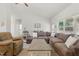 Spacious living room with a large sectional, bright windows and a ceiling fan at 38 Parkside Dr, Lillington, NC 27546
