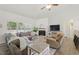 Bright living room featuring a fireplace, large windows, and stylish furnishings at 38 Parkside Dr, Lillington, NC 27546