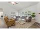 Bright living room featuring a large sectional sofa, neutral colors, and a ceiling fan at 38 Parkside Dr, Lillington, NC 27546