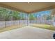 Covered patio overlooking the fenced backyard and wooded area at 38 Parkside Dr, Lillington, NC 27546