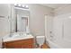 Bright bathroom with a single sink vanity and shower-tub combination at 3809 Volkswalk Pl, Raleigh, NC 27610