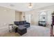 Cozy living room featuring a sectional sofa, neutral paint, and plush carpet flooring at 3809 Volkswalk Pl, Raleigh, NC 27610
