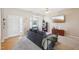 Bright living room with a cozy gray sofa, a large window, and a modern ceiling fan at 3809 Volkswalk Pl, Raleigh, NC 27610